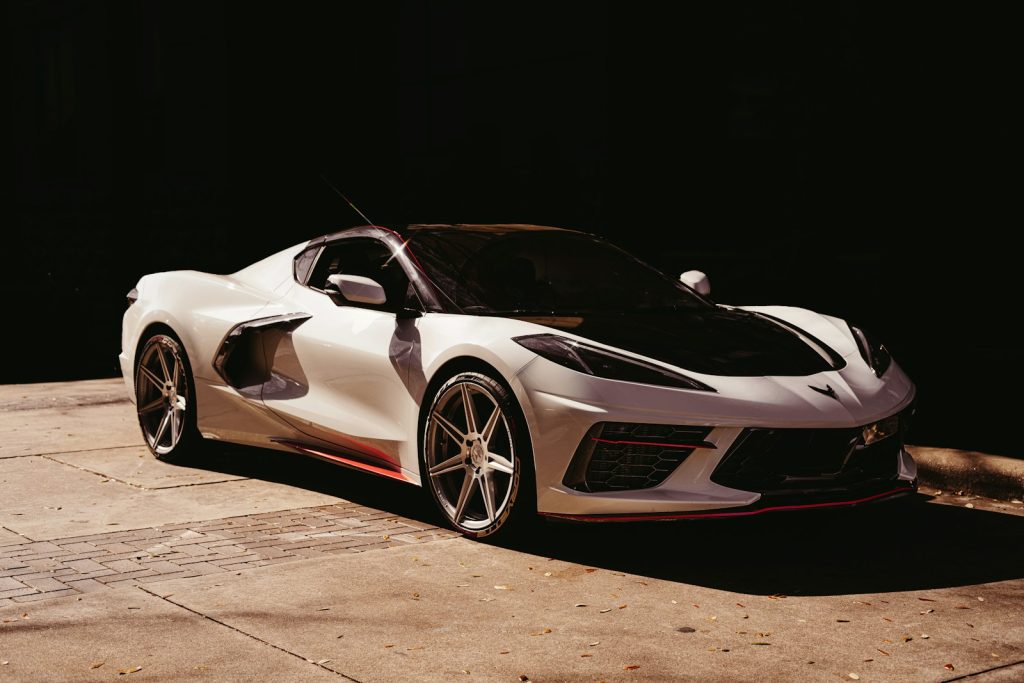 white lamborghini aventador in a dark room